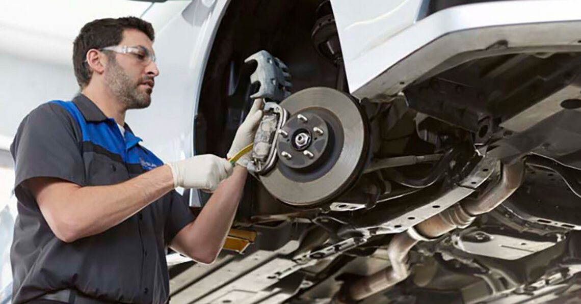 Subaru service technician working on brakes